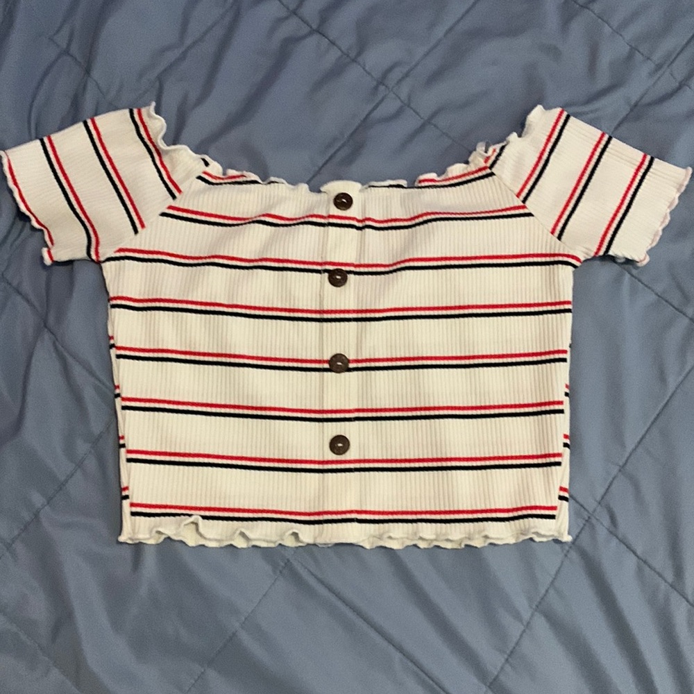 White top with red and black stripes and buttons